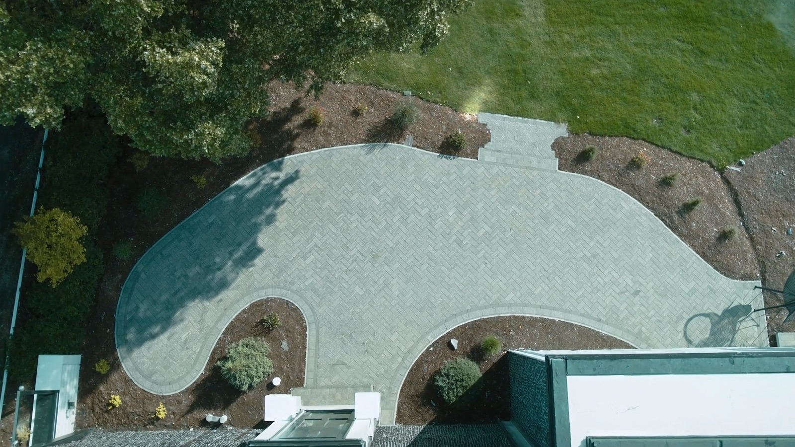 Aerial view of a completed paver patio and walkway at a Halifax residential home