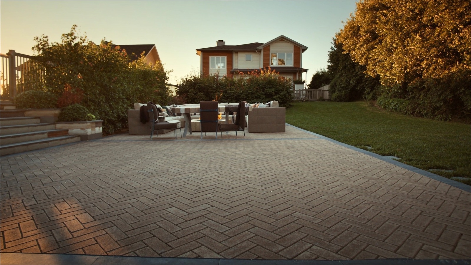 Completed paver patio with fire pit and outdoor seating on a Halifax residential property by Outworks Property Services